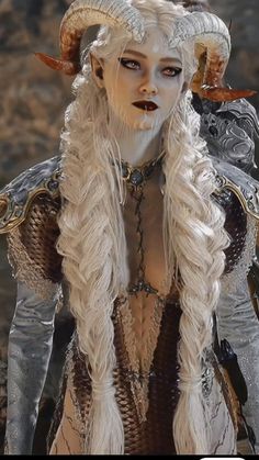 a woman with white hair and horns is dressed up as a horned god or demon