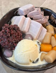 a black bowl filled with different types of food