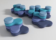 a group of blue and purple objects sitting on top of each other in front of a white background