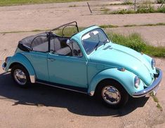 a small blue car parked in a parking lot