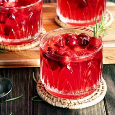 two glasses filled with cranberry punch and garnished with rosemary