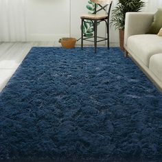 a living room with a blue rug on the floor