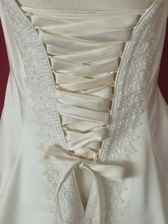 the back of a wedding dress with lace on it