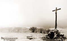 a black and white photo of a cross in the snow