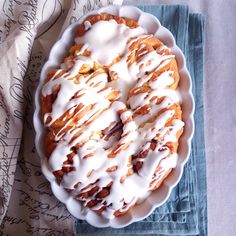 a pie with white icing on it sitting on top of a blue napkin