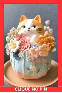 a cake decorated with flowers and a cat