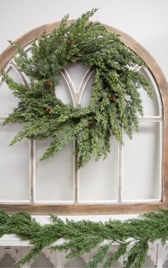 a wreath hanging on the side of a window