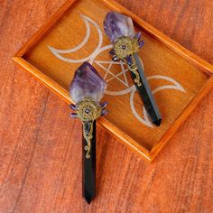 two amethysts are sitting in a wooden box