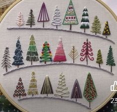 a cross stitch christmas tree pattern on a hoop