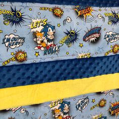 two blue and yellow bedspreads with cartoon characters on them, one has an image of sonic the hedgehog