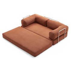 a large brown couch with two pillows on it's back and one arm extended