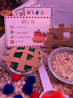 two pies are on display in front of a sign and other items for an apple pie