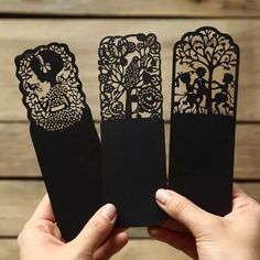 three pieces of paper cut out to look like bookmarks with trees and cats on them