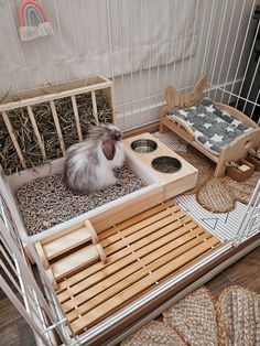 a hamster is sitting in its cage on the floor