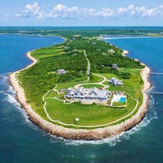 an aerial view of a large house in the middle of the ocean with lots of water around it