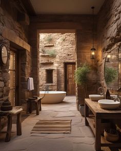 a bathroom with stone walls and flooring has a large bathtub in the middle