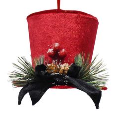 a red top hat decorated with pine cones and other holiday decorations on a white background