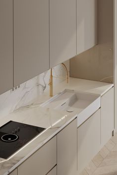 a kitchen with marble counter tops and white cupboards next to a stove top oven