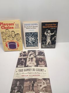 three books on baseball and other sports related items are laying next to each other in front of a white background