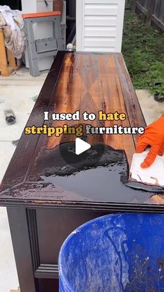 a person in an orange shirt is cleaning a table