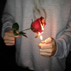 a person holding a rose with the words pyrismo on it