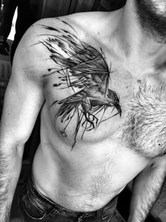 a man with a bird tattoo on his chest