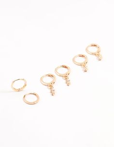 Elevate your look with this set of radiant, gold-toned hoop earrings, adorned with a dazzling cubic zirconia blend. Indulge in this stylish trio that lets you mix and match for endless accessorizing possibilities. Material: Cubic Zirconia Dimensions: Length 22mm x Width 3 mm | Lovisa Gold Dainty & Round Cubic Zirconia Hoop Earrings 3-Pack