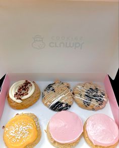 a box filled with lots of different flavored cookies and pastries on top of each other