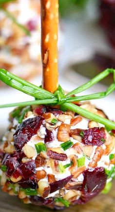 an appetizer with nuts, cranberry sauce and green onions on it