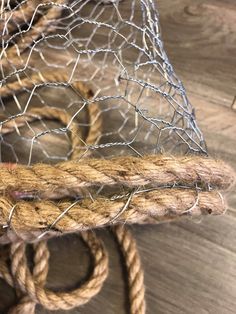 a close up of a rope and net on a wooden table with knots around it