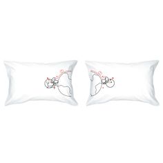 two white pillows sitting next to each other