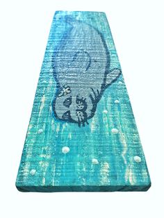 an elephant painted on the side of a piece of wood with bubbles and water around it