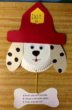 a paper plate with a dog wearing a fireman's hat on top of it