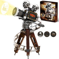 an old fashioned movie projector on a tripod next to some discs and cds