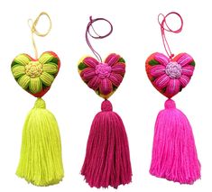 three heart shaped tassels with flowers on them