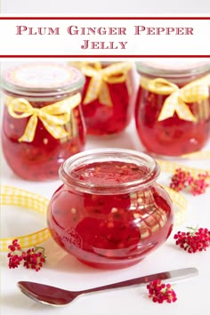 several jars filled with red liquid next to a yellow ribbon