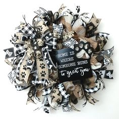 a black and white wreath that says home is where someone runs to give you some