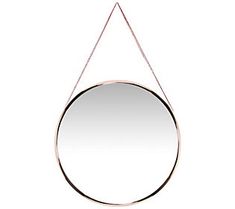 a round mirror hanging on a chain