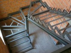 an old metal stair case on the side of a brick wall