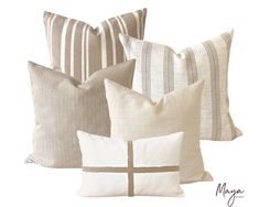 four pillows with white and brown stripes on them