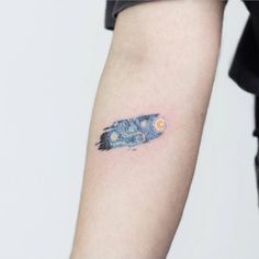 a person with a tattoo on their arm that has the starry night painting on it