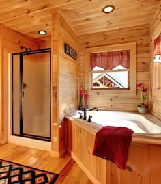 a bathroom with a large tub and wooden walls