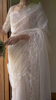 a woman in a white dress holding a bouquet