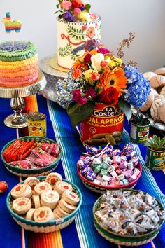 an assortment of desserts and sweets on a table with a blue striped table cloth