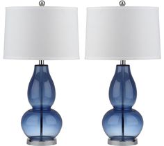 two blue glass lamps with white shades on each lamp and one is turned off to the side