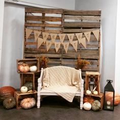 a bed made out of pallets with pumpkins and other decorations on the floor