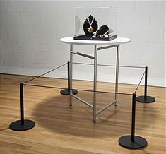 three black and white tables with jewelry on them