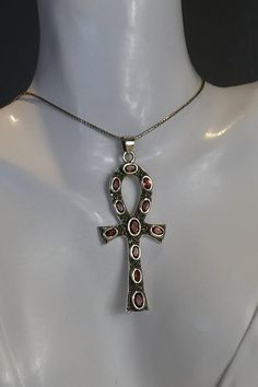 A fine vintage silver celtic style cross set with 11 oval cut garnets surrounded by marcasite stones. hangs from an 18 inch silver snake style chain. cross measures 2.7cm wide x 6.2cm high. stamped 925 for silver . all stones tested genuine. Vintage Silver Ankh Jewelry, Celtic Style, Celtic Cross, Vintage Silver, Garnet, Silver Chain, Beading, Jewelry Necklace Pendant, Jewelry Necklaces