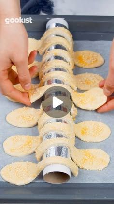 someone making tortilla shells on top of a baking sheet with the shell cut out