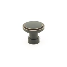 an image of a knob on a white background with a black and gold finish to it